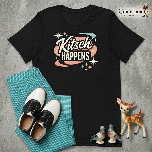 High-contrast white and teal typography for the slogan "Kitsch Happens" centered on a dark Bella+Canvas 3001 t-shirt in Heather Black. The font is an elegant 1950s script style with a small atomic-age starburst. 
