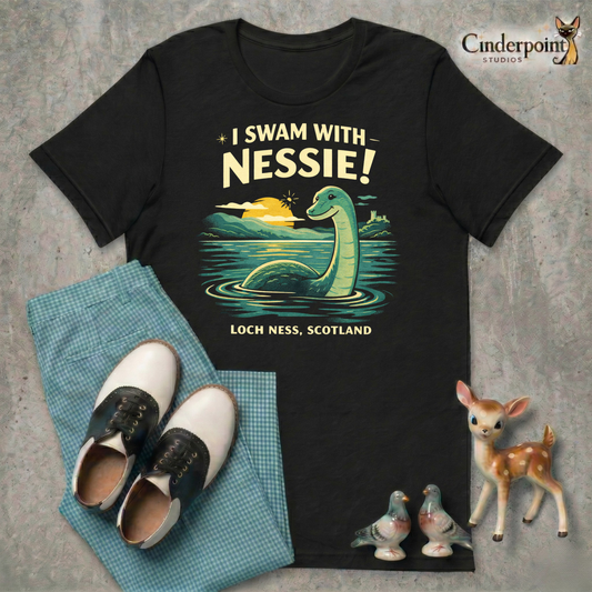A retro cryptid travel t-shirt featuring Nessie in Loch Ness, Scotland with scenic vintage-style artwork and playful souvenir-shirt charm.