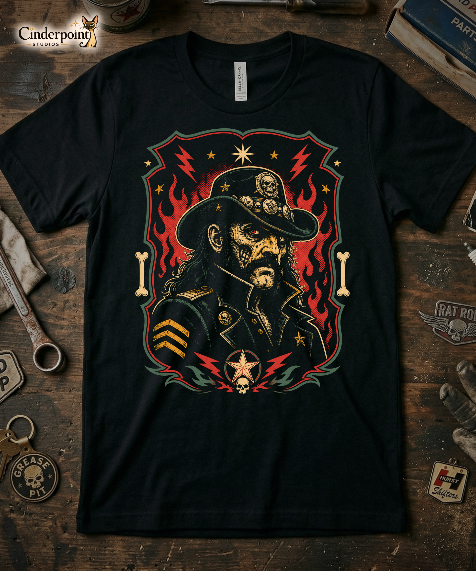 Graphic t-shirt design featuring a lowbrow undead version of Lemmy in a military-style hat with skulls and stars, framed by red flames and lightning bolts on a black background.