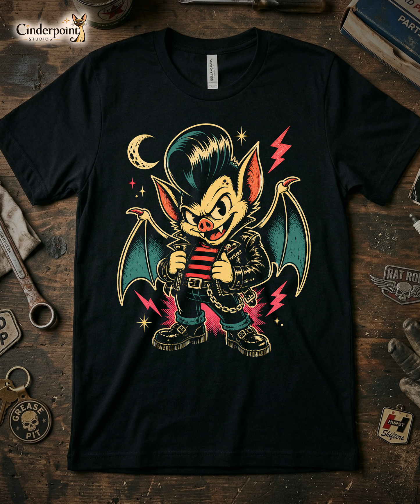 A cartoon-style vampire bat greaser with a pompadour, wearing a leather jacket and striped shirt, standing in a defiant pose with lightning bolts and a crescent moon on our premium black tee.