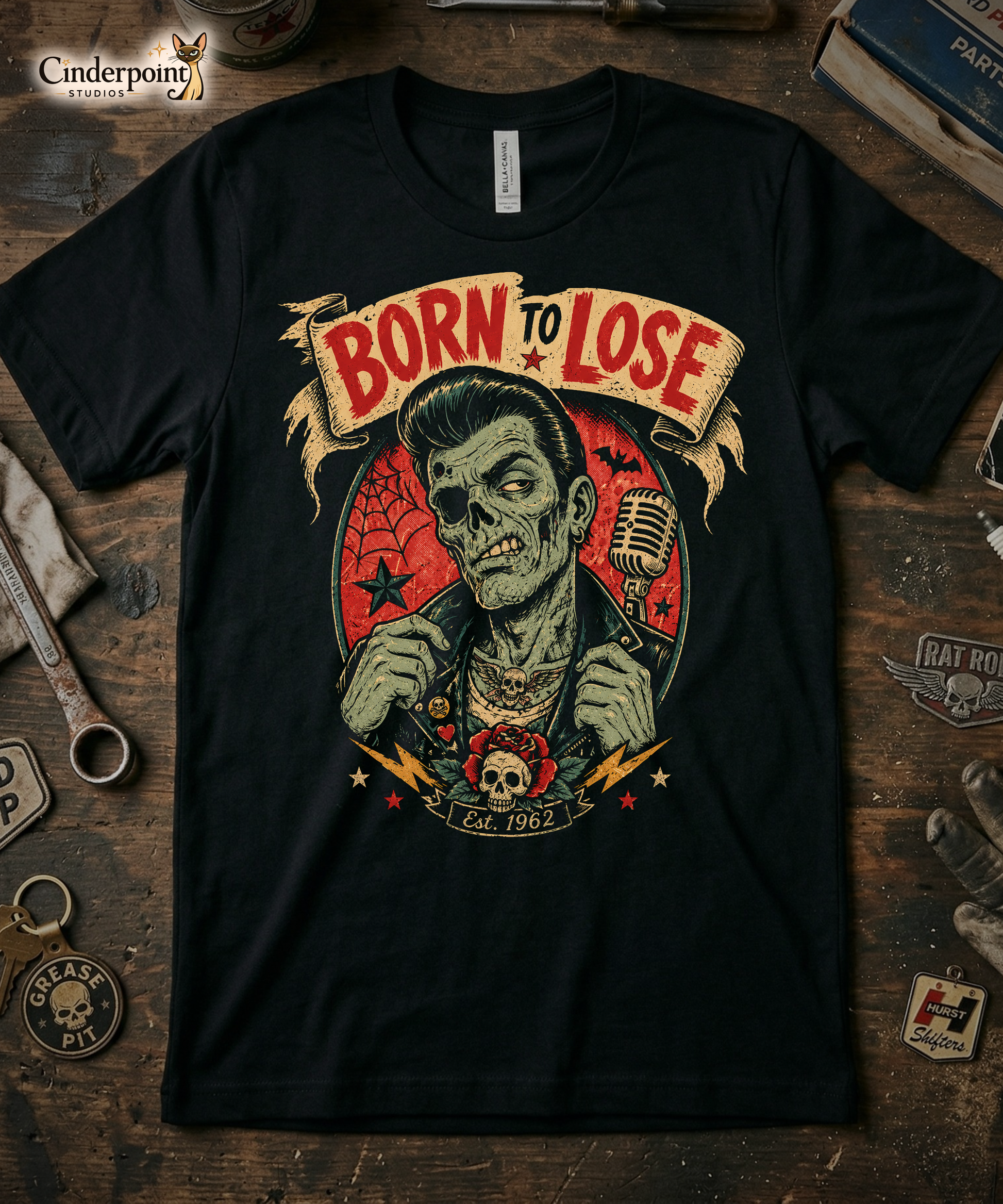 A vintage tattoo flash-style graphic on a black t-shirt featuring a green-skinned zombie monster with a banner that says "Born to Lose"