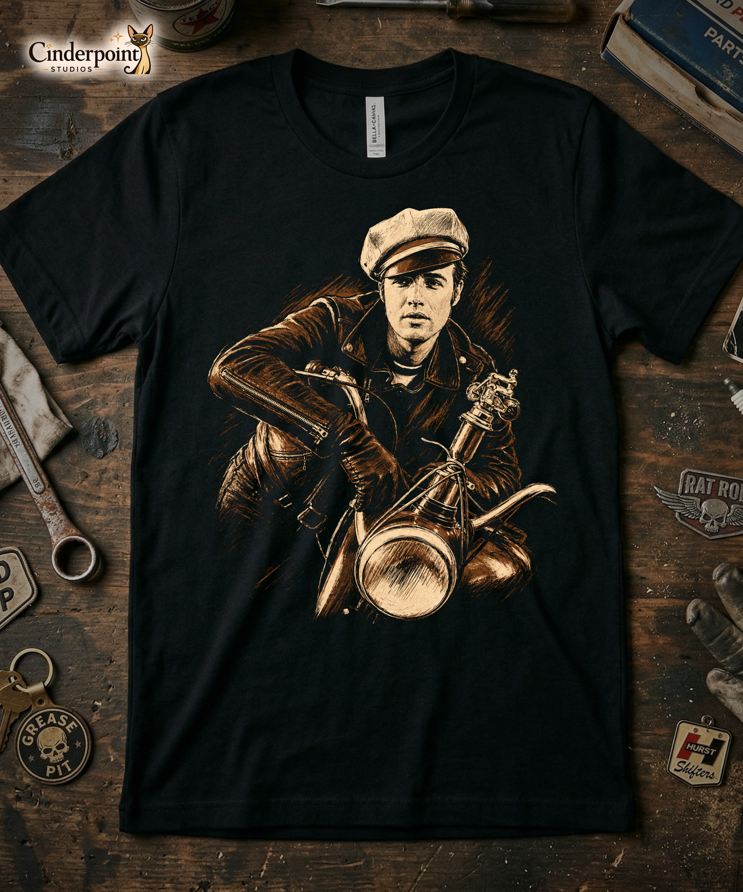 A high-contrast artistic portrait of Marlon Brando as Johnny from The Wild One on a black t-shirt, featuring his iconic tilted biker cap and leather jacket.