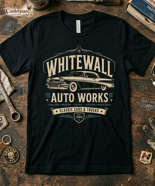 Black graphic tee featuring original Cinderpoint Studios artwork for Tailfin Classics, a retro auto service center design with a 1950s-style classic car, bold tailfins, vintage lettering, teal accents, crossed wrenches, spark plugs, and Alignment Brakes Suspension text.