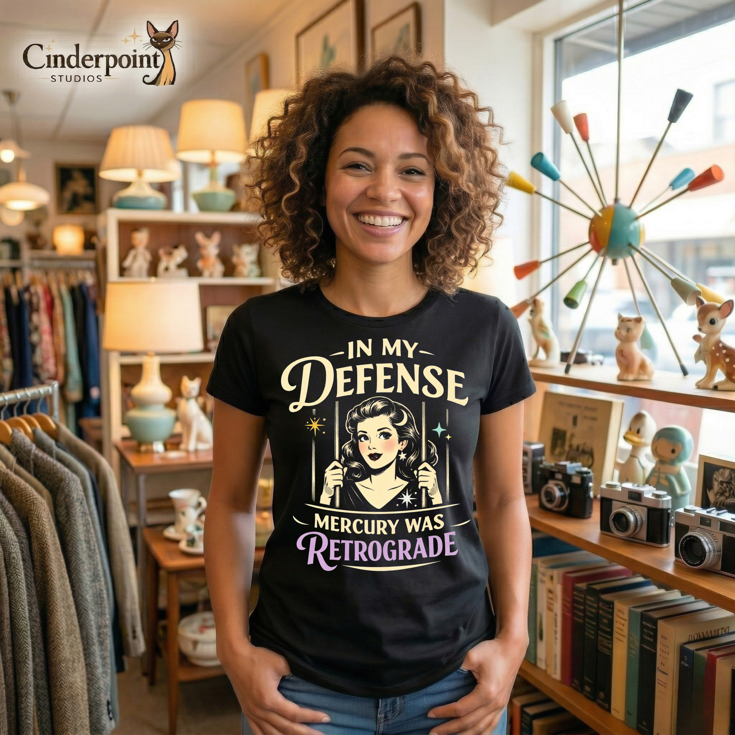 Black retro graphic t-shirt featuring a vintage-inspired woman behind bars with the phrase In My Defense Mercury Was Retrograde in cream and lavender lettering.