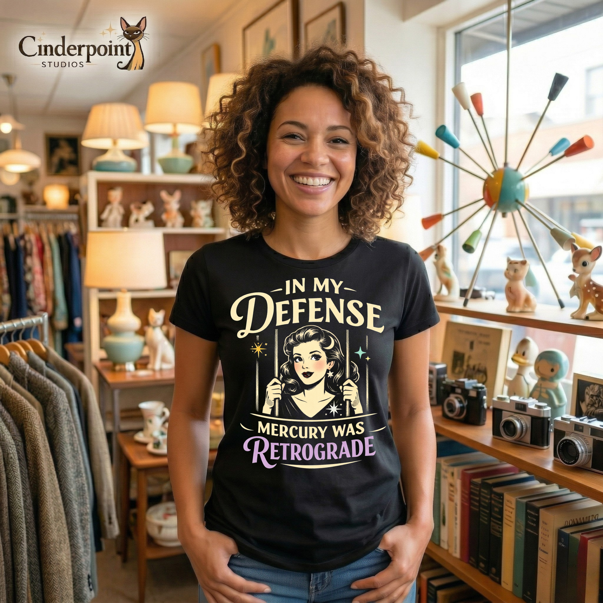 Black retro graphic t-shirt featuring a vintage-inspired woman behind bars with the phrase In My Defense Mercury Was Retrograde in cream and lavender lettering.