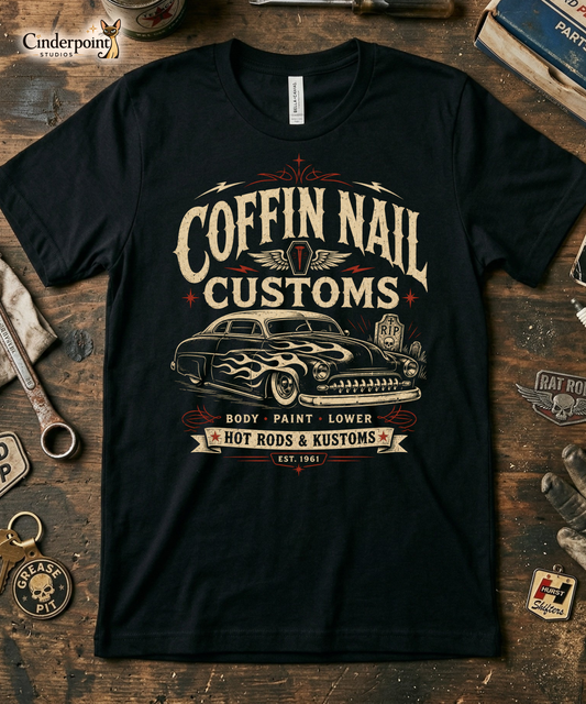 Black graphic tee featuring original Cinderpoint Studios artwork for Coffin Nail Customs, a psychobilly hot rod design with bold distressed lettering, a chopped custom lead sled, flame graphics, winged coffin nail emblem, lightning bolts, cemetery details, and Hot Rods & Kustoms text.
