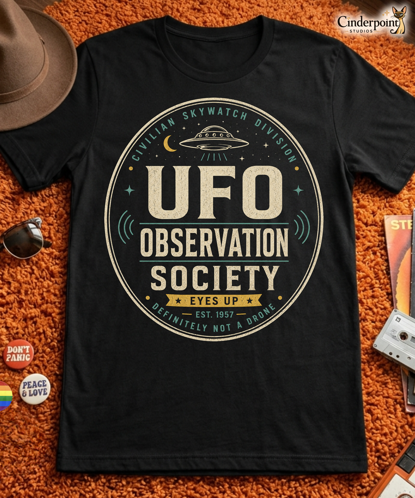 UFO Observation Society t-shirt design with vintage oval badge layout, flying saucer, moon, stars, and Civilian Skywatch Division text