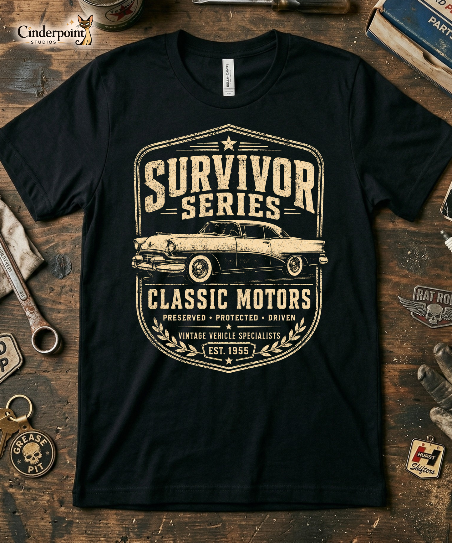 Black graphic tee featuring original Cinderpoint Studios artwork for Survivor Series Classic Motors, a one-color vintage car badge design with a classic car profile, bold retro lettering, laurel accents, and Preserved Protected Driven text.