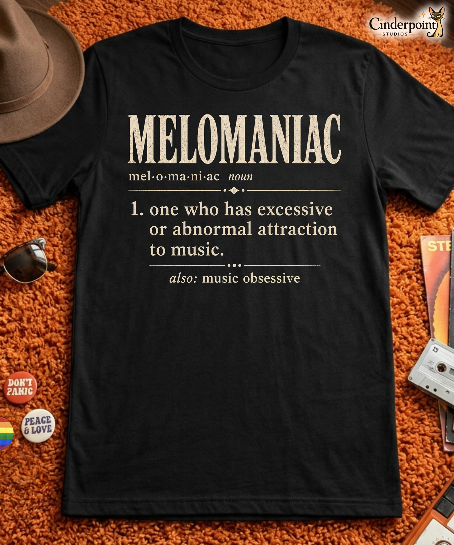 Black graphic tee with Melomaniac definition design for music lovers and audiophiles by Cinderpoint Studios