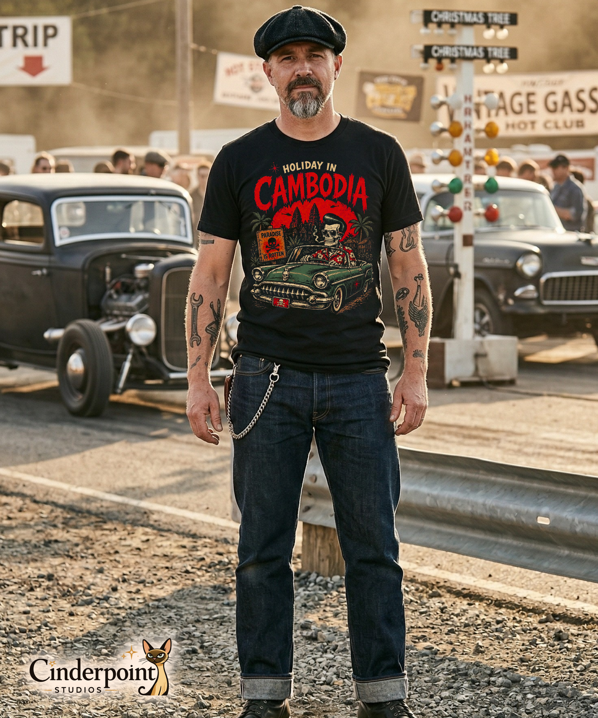A detailed lowbrow graphic on a black t-shirt featuring a skeleton with a pompadour driving a 1955 Chevy convertible. The background shows Angkor Wat under a red sun with helicopters, and a sign that reads 'Paradise is Rotten'.