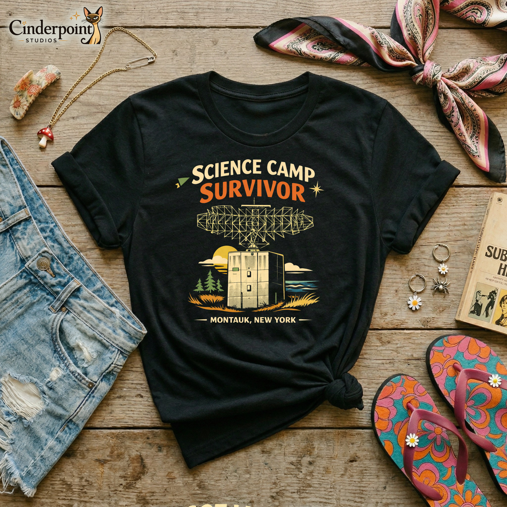 Black retro graphic t-shirt featuring the phrase Science Camp Survivor above a vintage-style radar tower illustration with Montauk, New York text below.