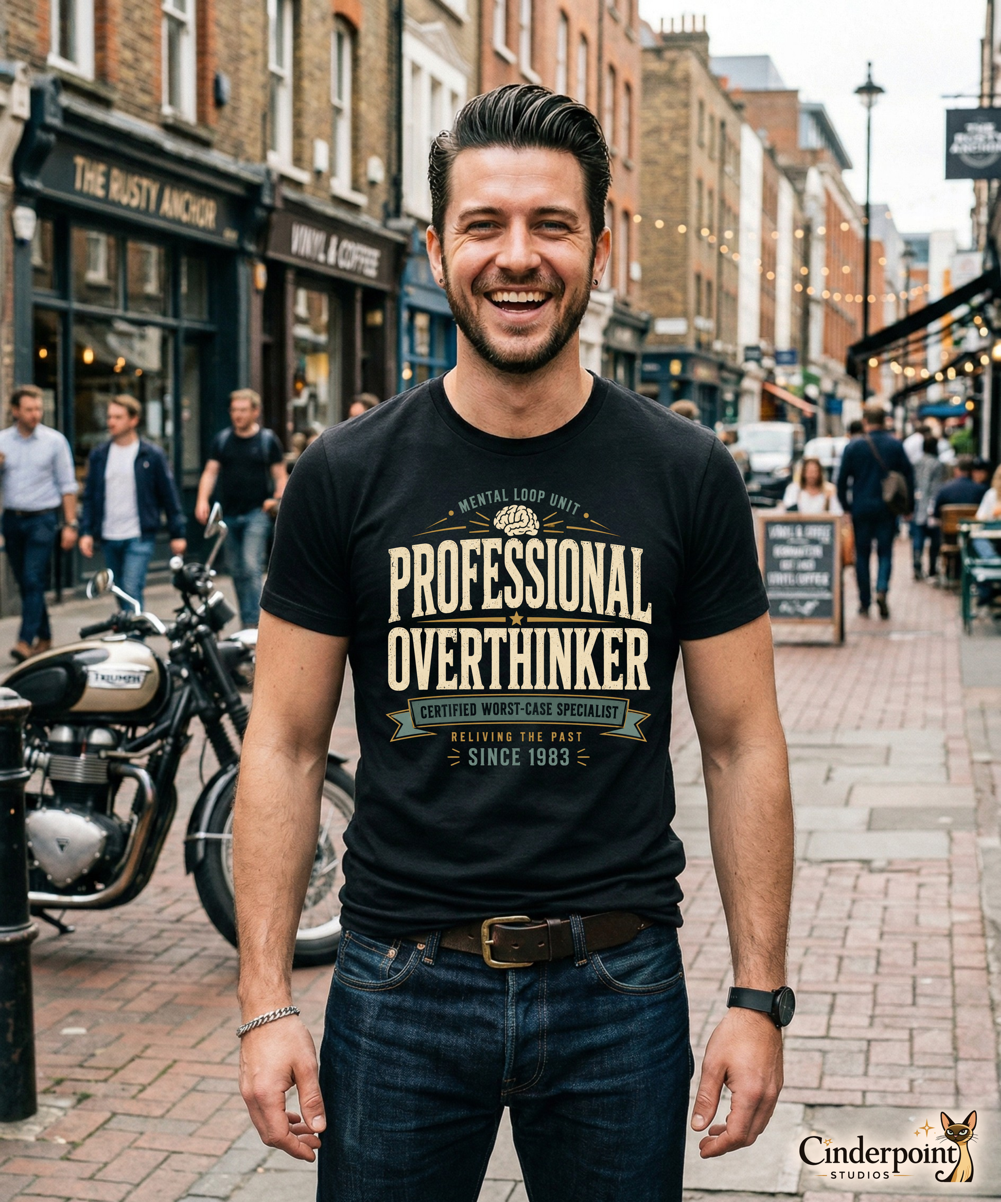 Male model wearing a black graphic tee with the Professional Overthinker design by Cinderpoint Studios, featuring retro badge-style lettering, a brain graphic, and Mental Loop Unit text.