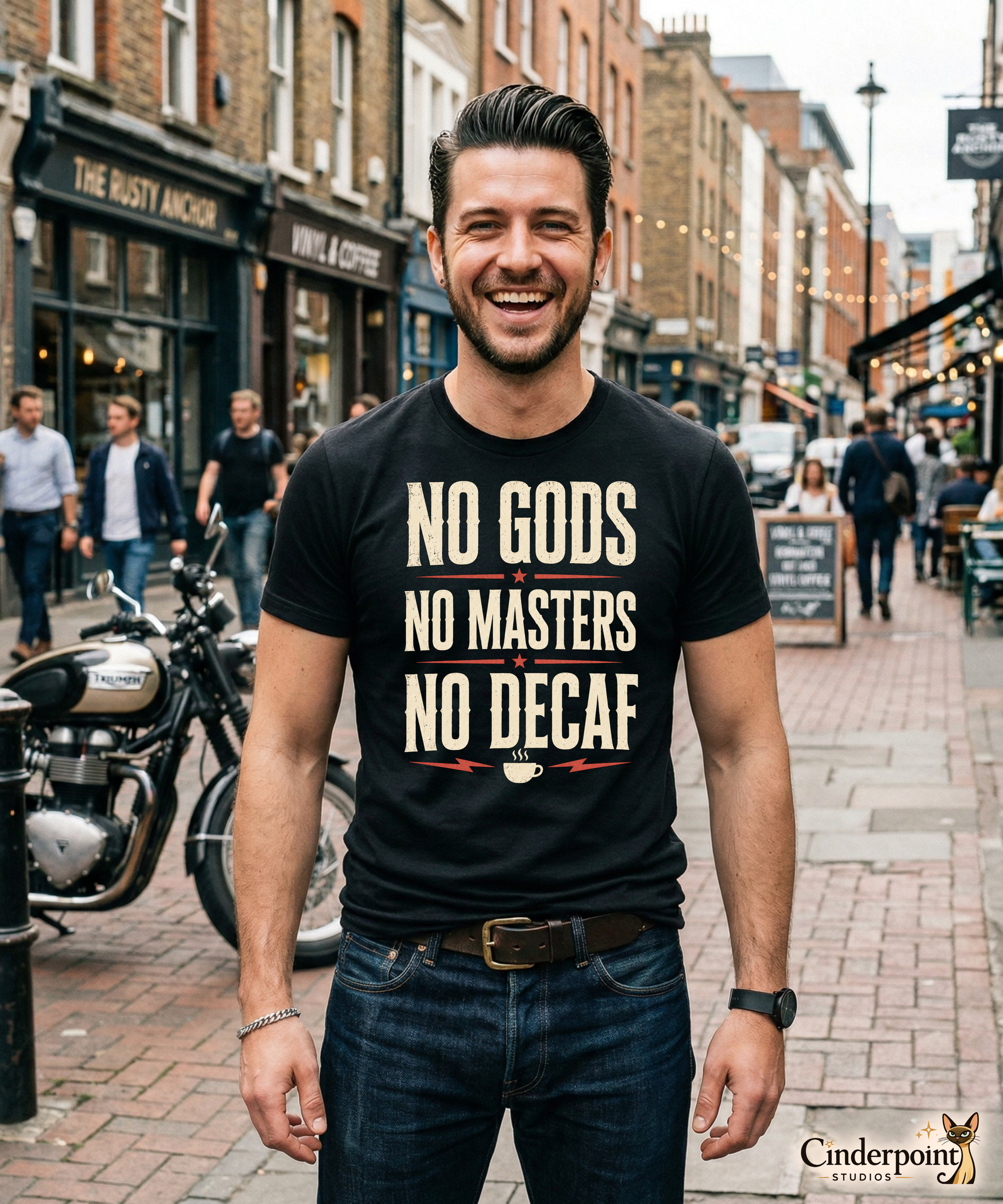 A man on the street wearing a black graphic tee with the No Gods No Masters No Decaf artwork by Cinderpoint Studios, styled as a boutique retro coffee humor shirt with bold slogan typography and red accent details.