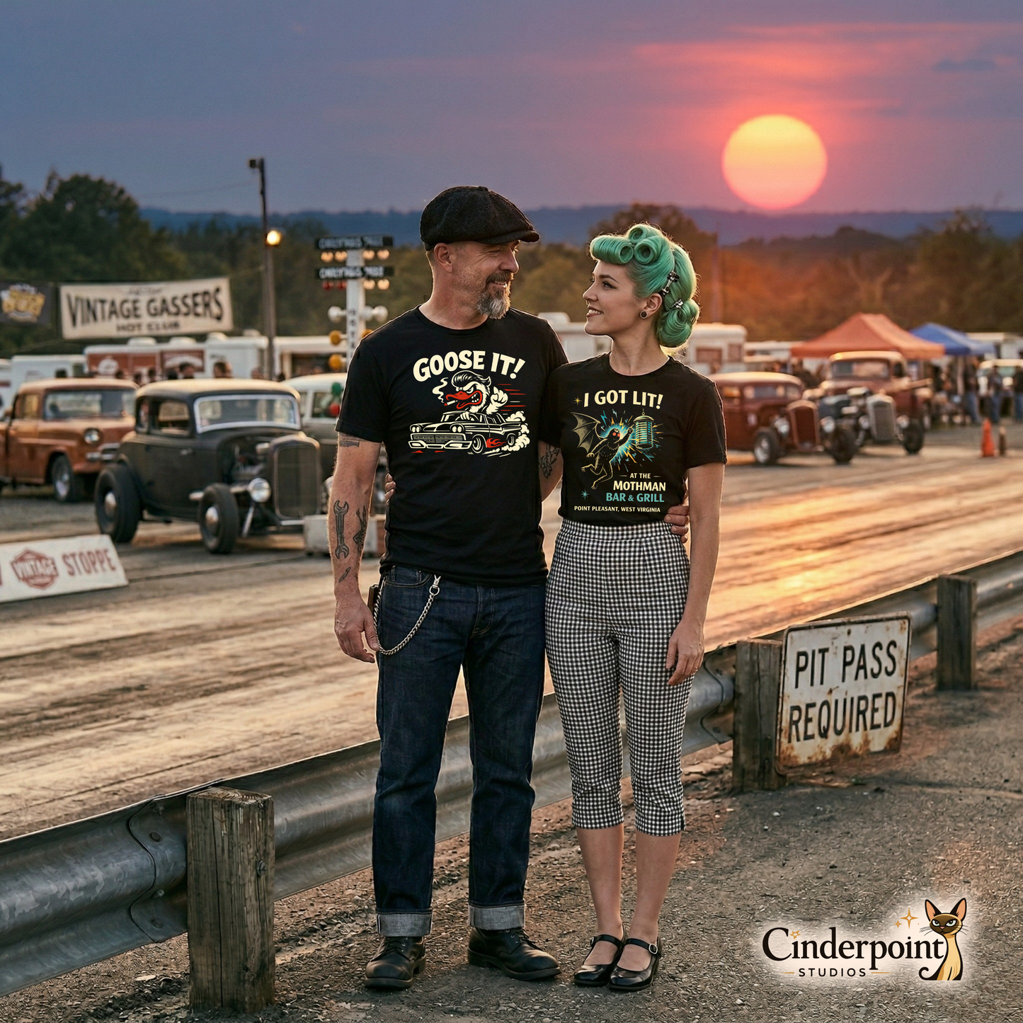 A rockabilly couple standing at a sunset drag strip; the man wears the "Goose It!" goose tee and the woman wears her "I Got Lit at the Mothman Bar & Grill" t-shirt.