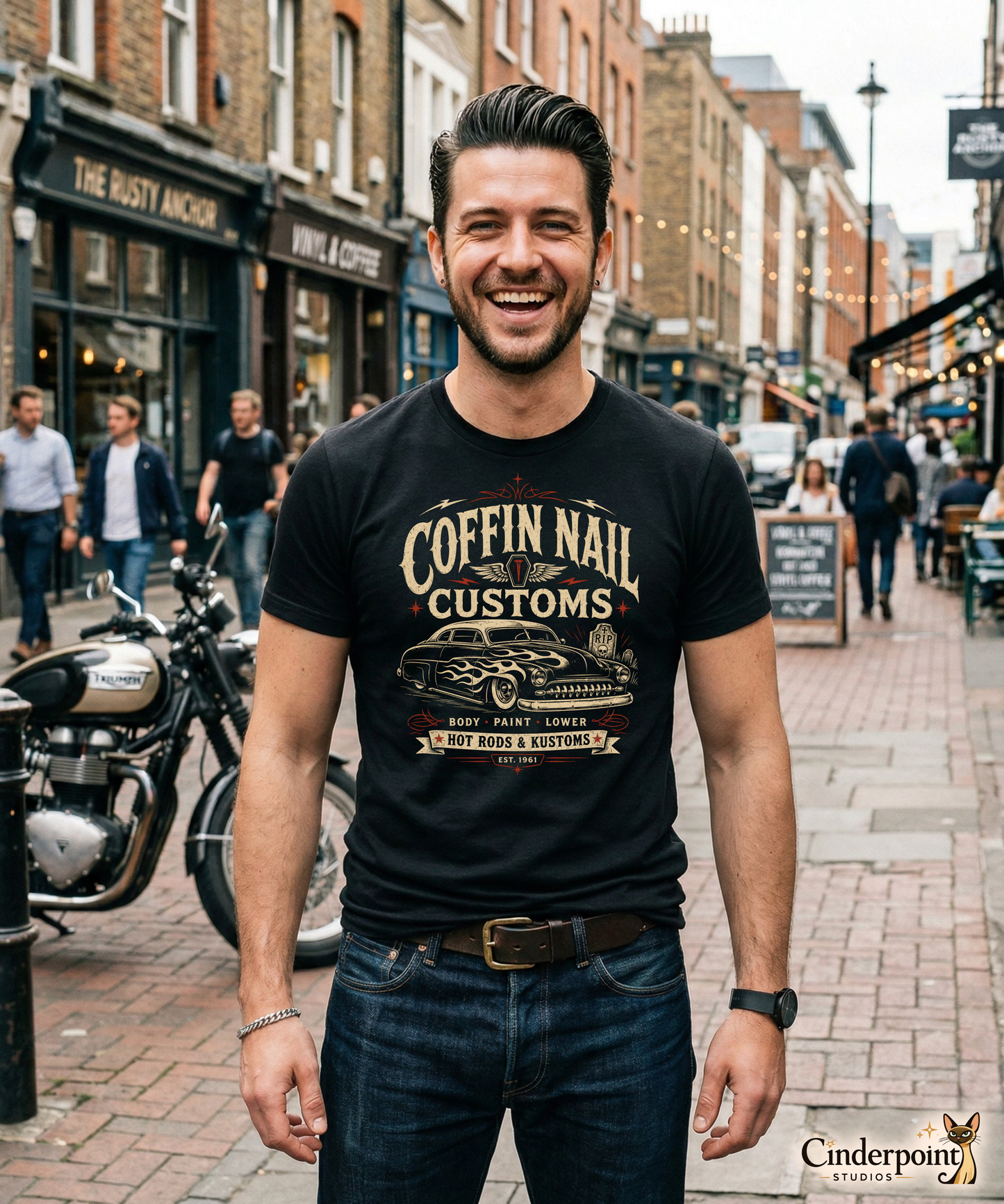 Black graphic tee featuring original Cinderpoint Studios artwork for Coffin Nail Customs, a psychobilly hot rod design with bold distressed lettering, a chopped custom lead sled, flame graphics, winged coffin nail emblem, lightning bolts, cemetery details, and Hot Rods & Kustoms text.
