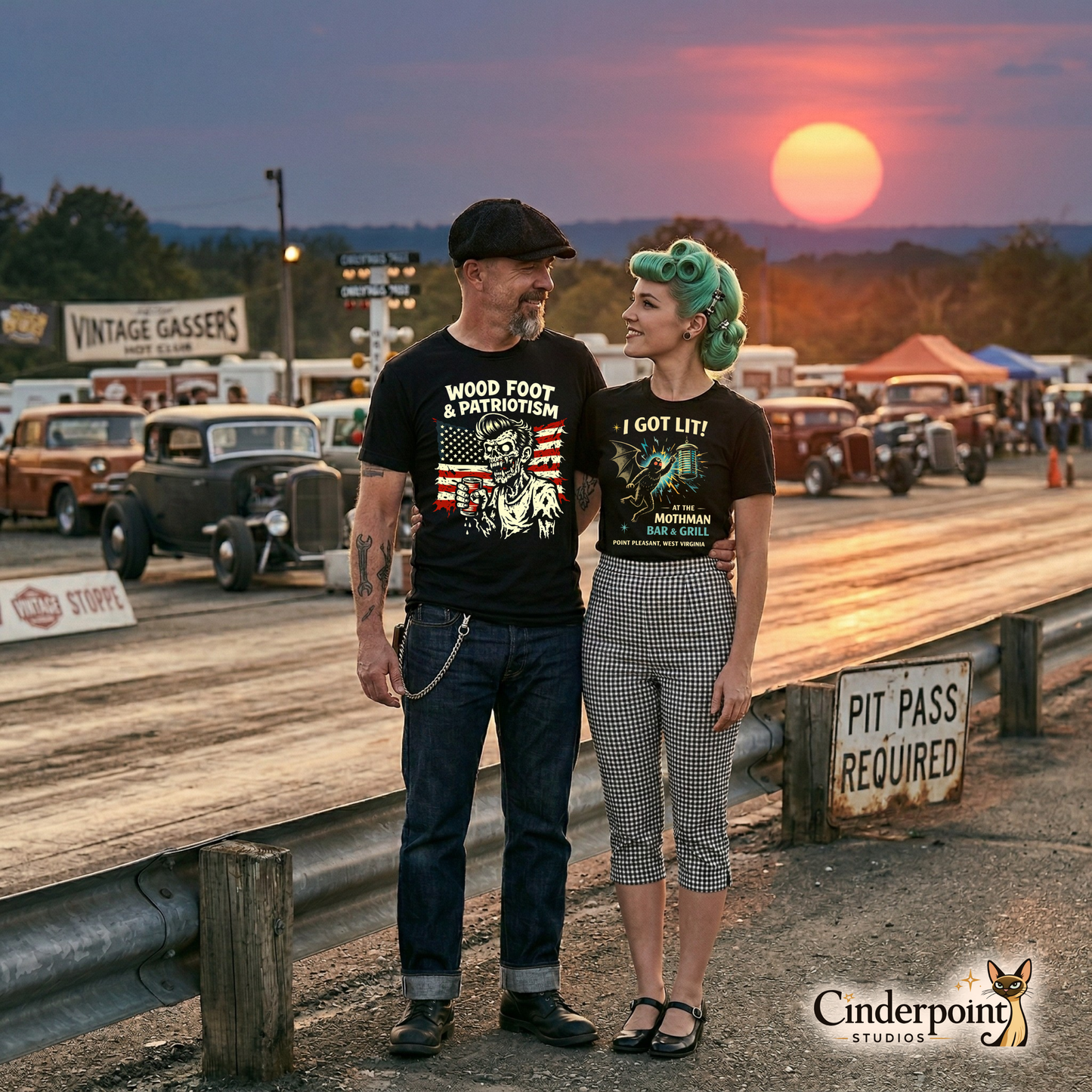 A rockabilly couple standing at a drag strip during sunset. The man wears the "Wood Foot" tee, and the woman wears her favorite Mothman-themed black t-shirt.