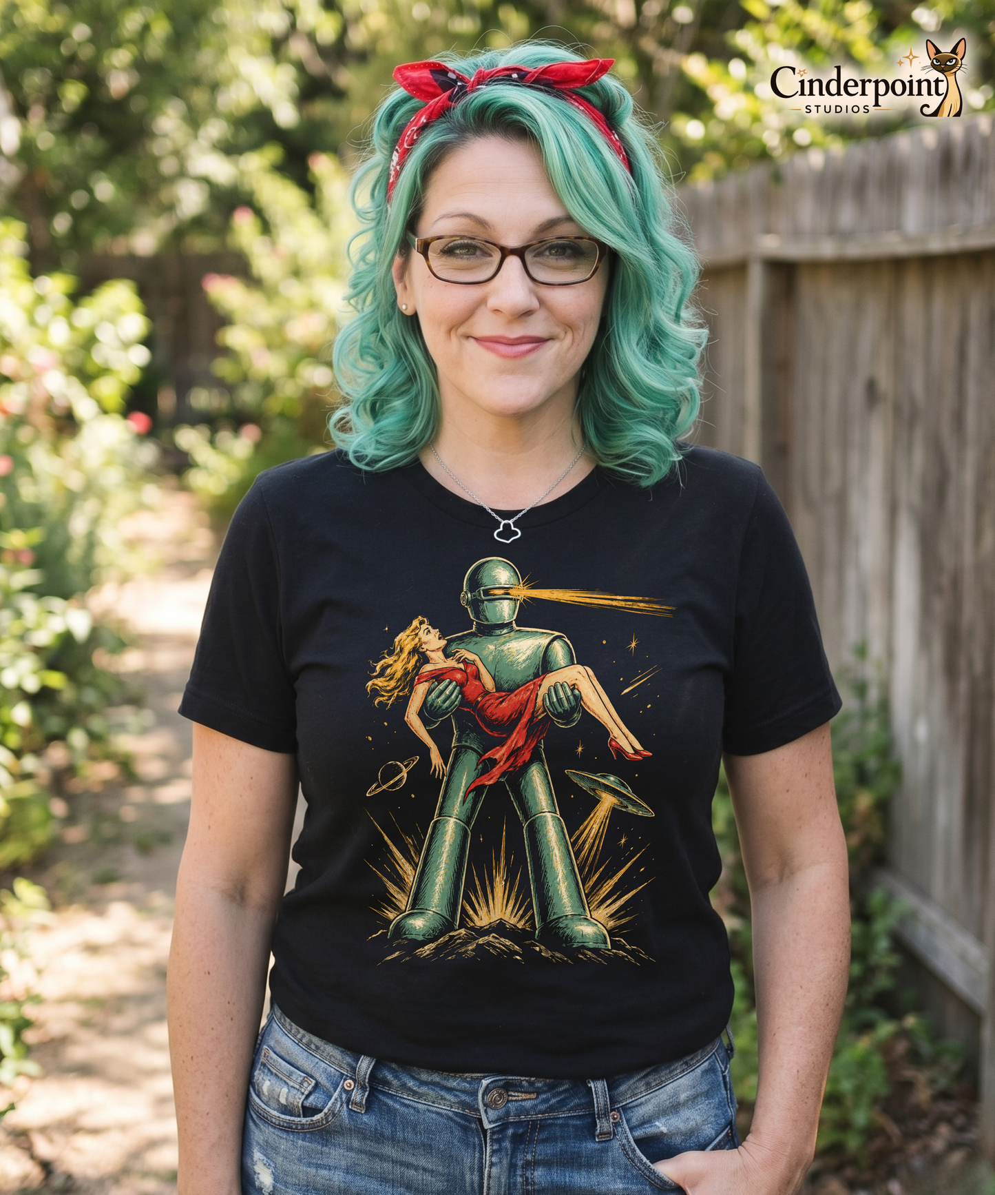 The designer, Auntie Mel, is wearing her retro, high-contrast graphic on a black t-shirt featuring the robot Gort from the 1951 film The Day The Earth Stood Still, with a sleek metallic aesthetic