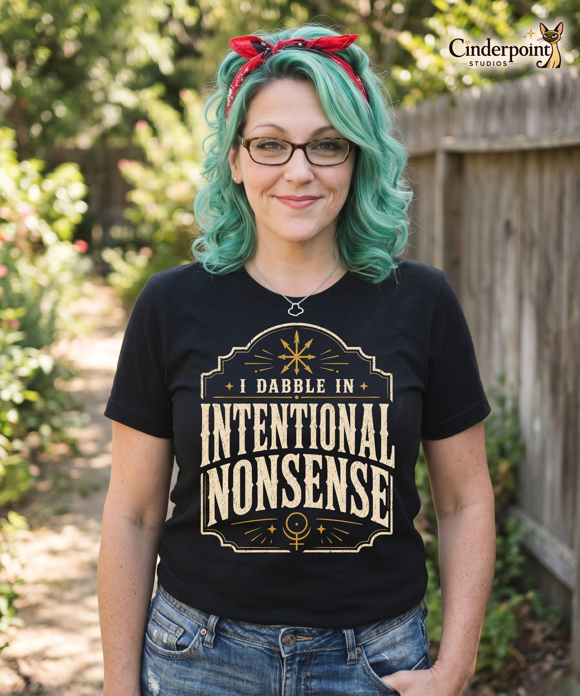 Woman wearing black Intentional Nonsense graphic tee with cream lettering and gold decorative details
