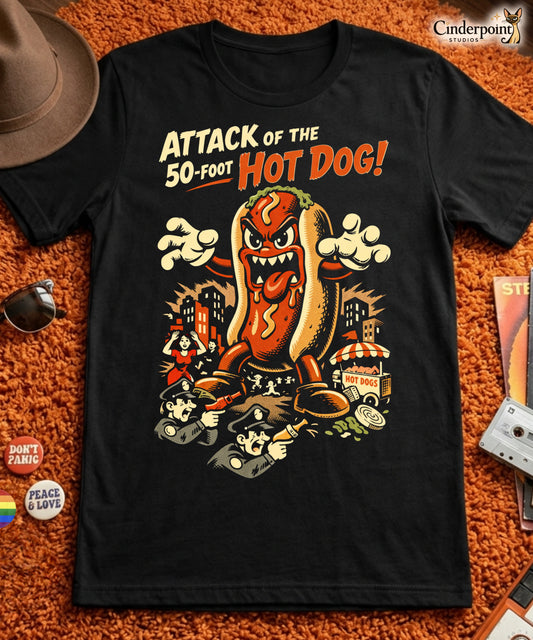 A retro B-movie style graphic t-shirt featuring a giant 50-foot hot dog attacking a vintage city skyline, with campy horror-themed cinematic lettering.