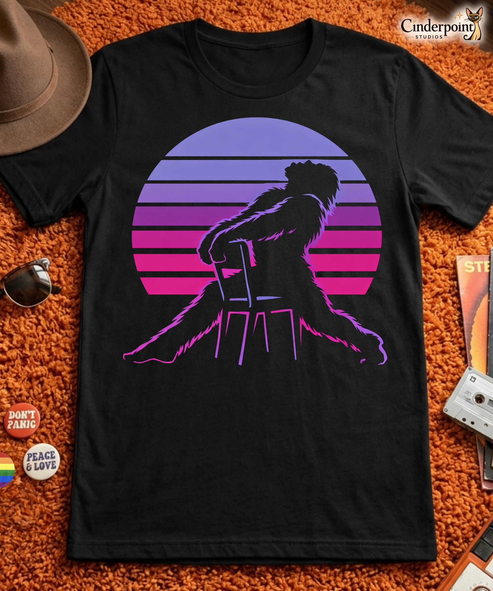 A retro graphic t-shirt featuring the cryptid Bigfoot in the iconic Flashdance chair-pose silhouette against a vibrant 1980s-style sunset.