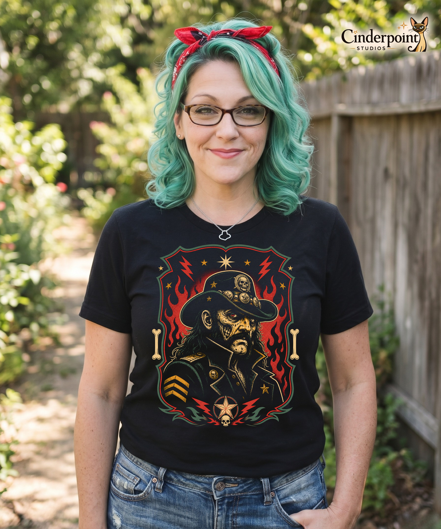 Graphic t-shirt design featuring a lowbrow undead version of Lemmy in a military-style hat with skulls and stars, framed by red flames and lightning bolts on a black background.