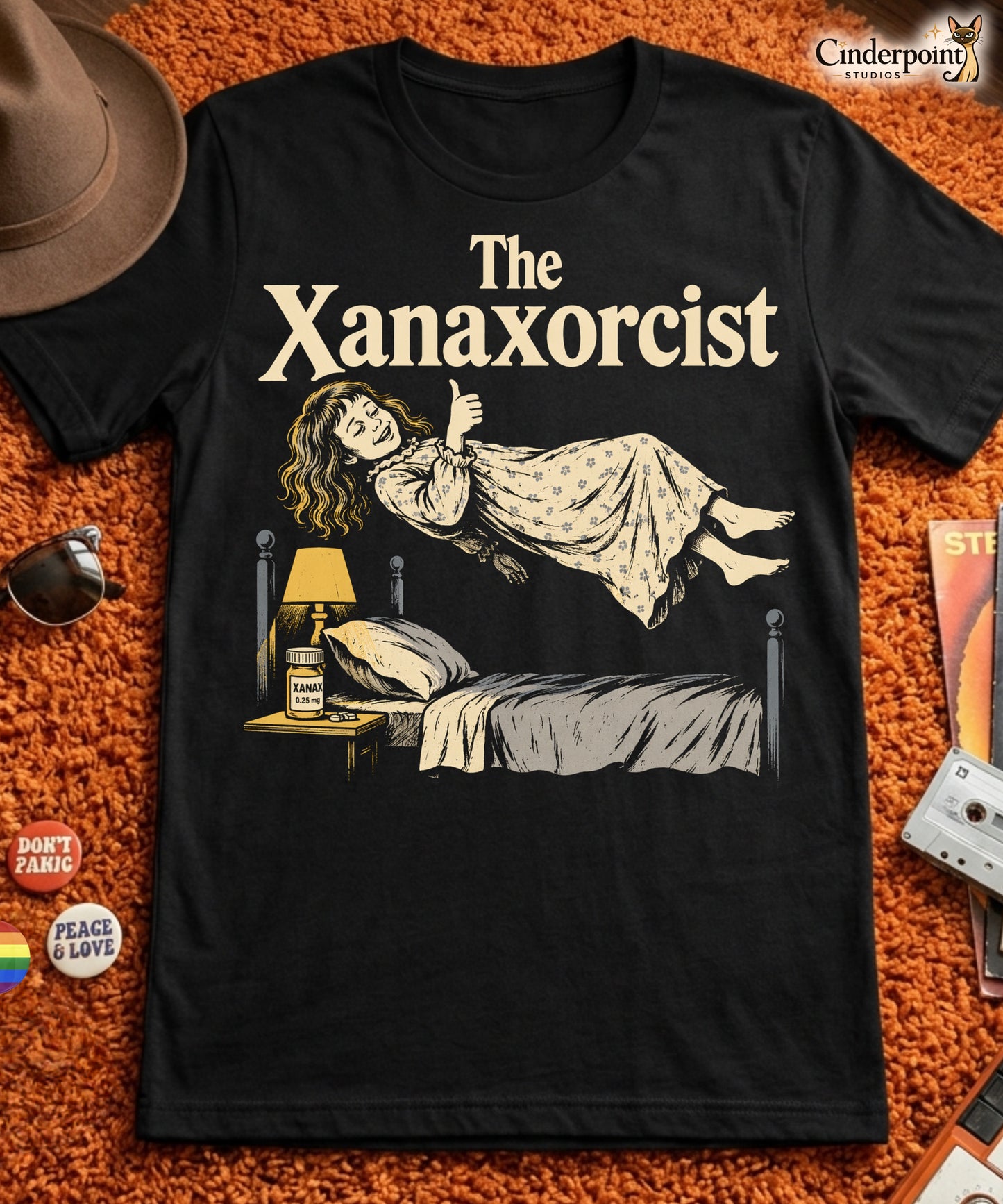 A retro horror-style graphic t-shirt featuring "The Xanaxorcist" in classic cinematic lettering with a stylized, eerie parody of the iconic exorcism scene.