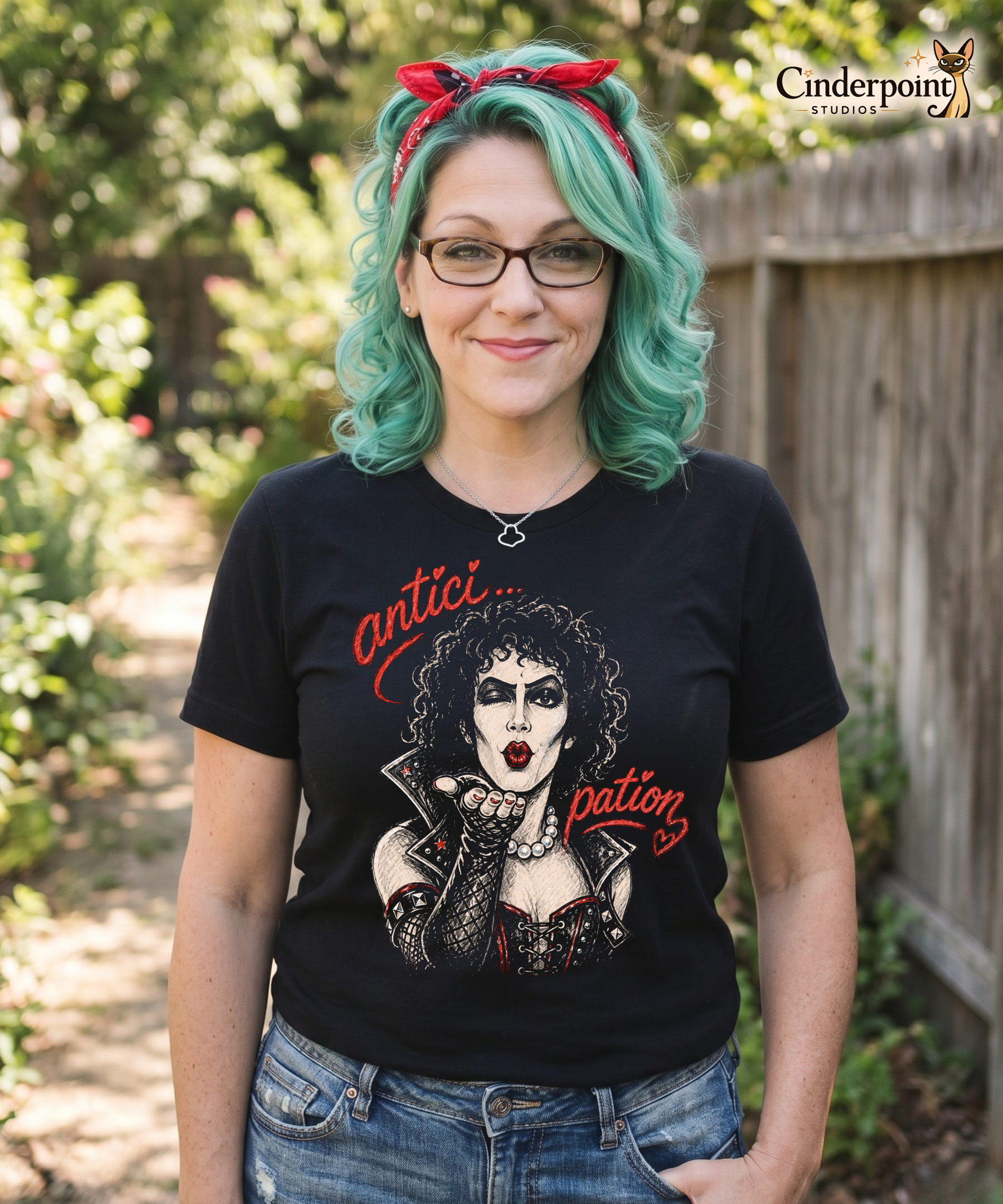 A gritty, high-contrast artistic portrait of Frank N. Furter on a black t-shirt, featuring his iconic curls and makeup with the word "ANTICIPATION" in distressed lipstick lettering.