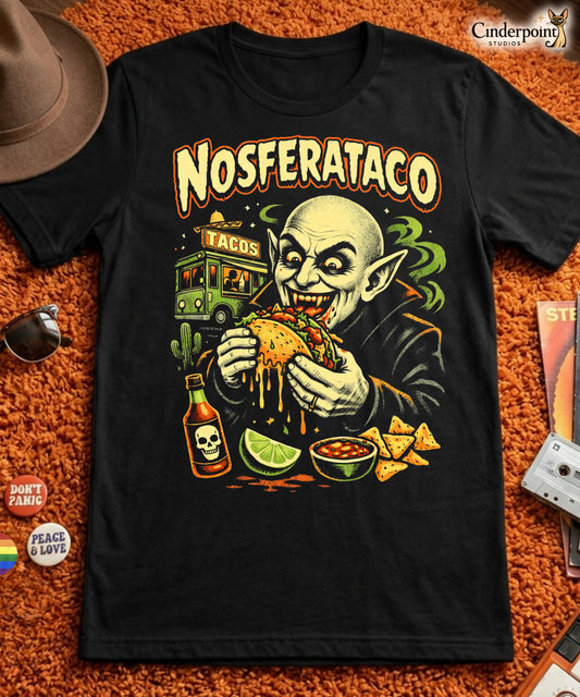 A retro horror-style graphic t-shirt featuring the vampire Nosferatu holding a taco, with "Nosferataco" in stylized, campy cinematic lettering.