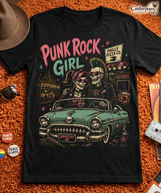 A retro-style graphic on a black t-shirt featuring two skeletons—a male with a mohawk and a female with a pink bow—driving a teal 1955 Chevy past iconic Philadelphia punk landmarks.