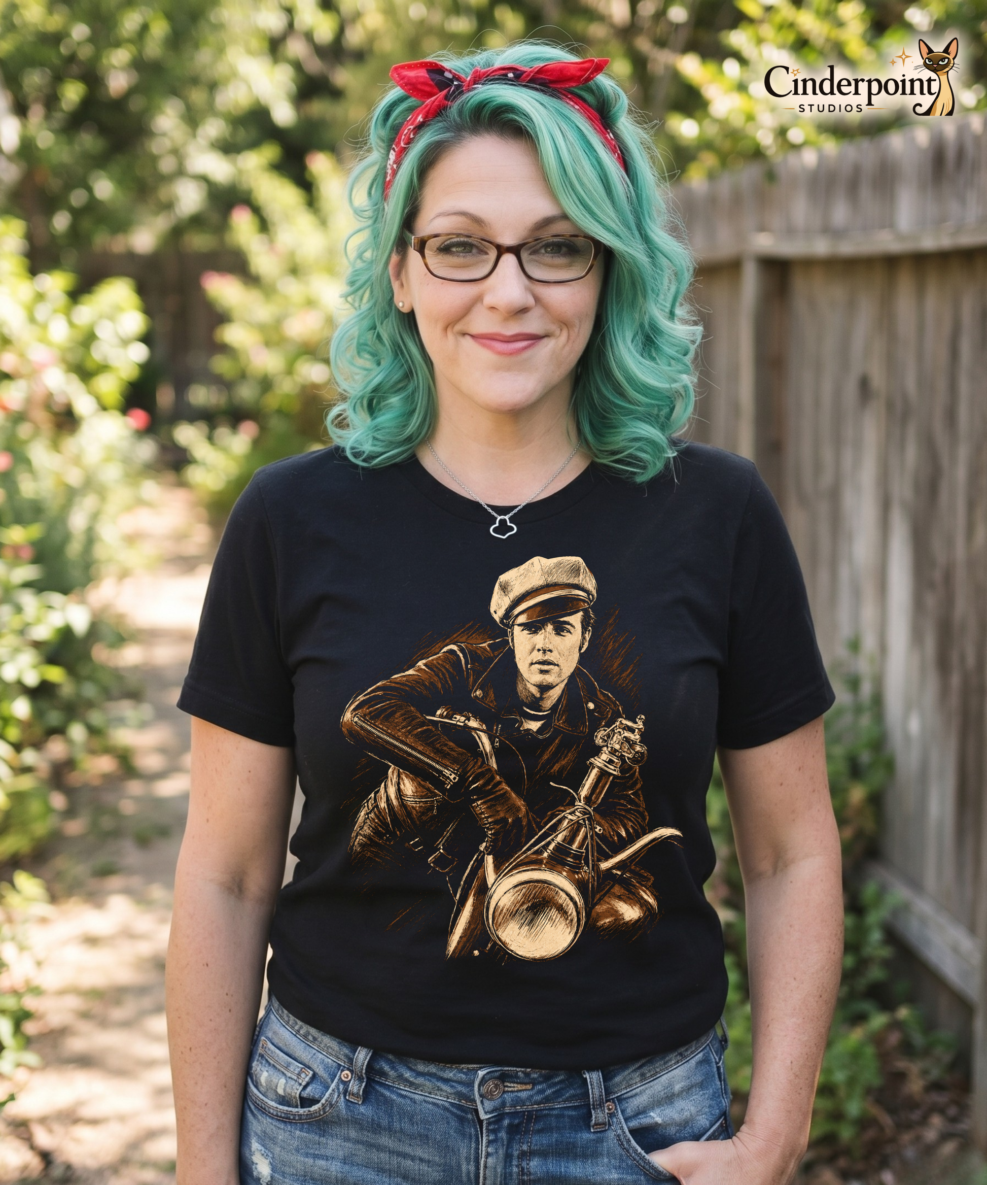 The designer, Auntie Mel, wearing A high-contrast artistic portrait of Marlon Brando as Johnny from The Wild One on a black t-shirt, featuring his iconic tilted biker cap and leather jacket.