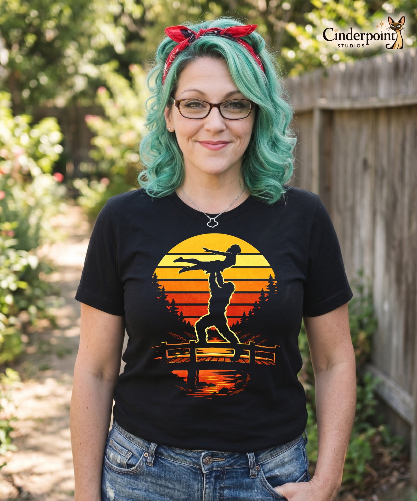A retro-style graphic t-shirt featuring the cryptid Bigfoot performing the iconic Dirty Dancing lift pose against a vibrant, multi-colored 80s sunburst background.