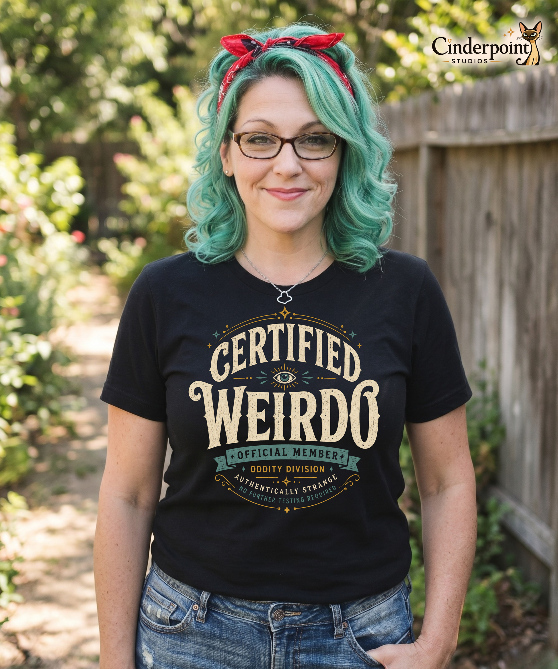 Female model wearing a black graphic tee with the Certified Weirdo artwork by Cinderpoint Studios, styled as a boutique retro weirdo shirt with all-seeing eye details, Oddity Division text, and Authentically Strange wording.