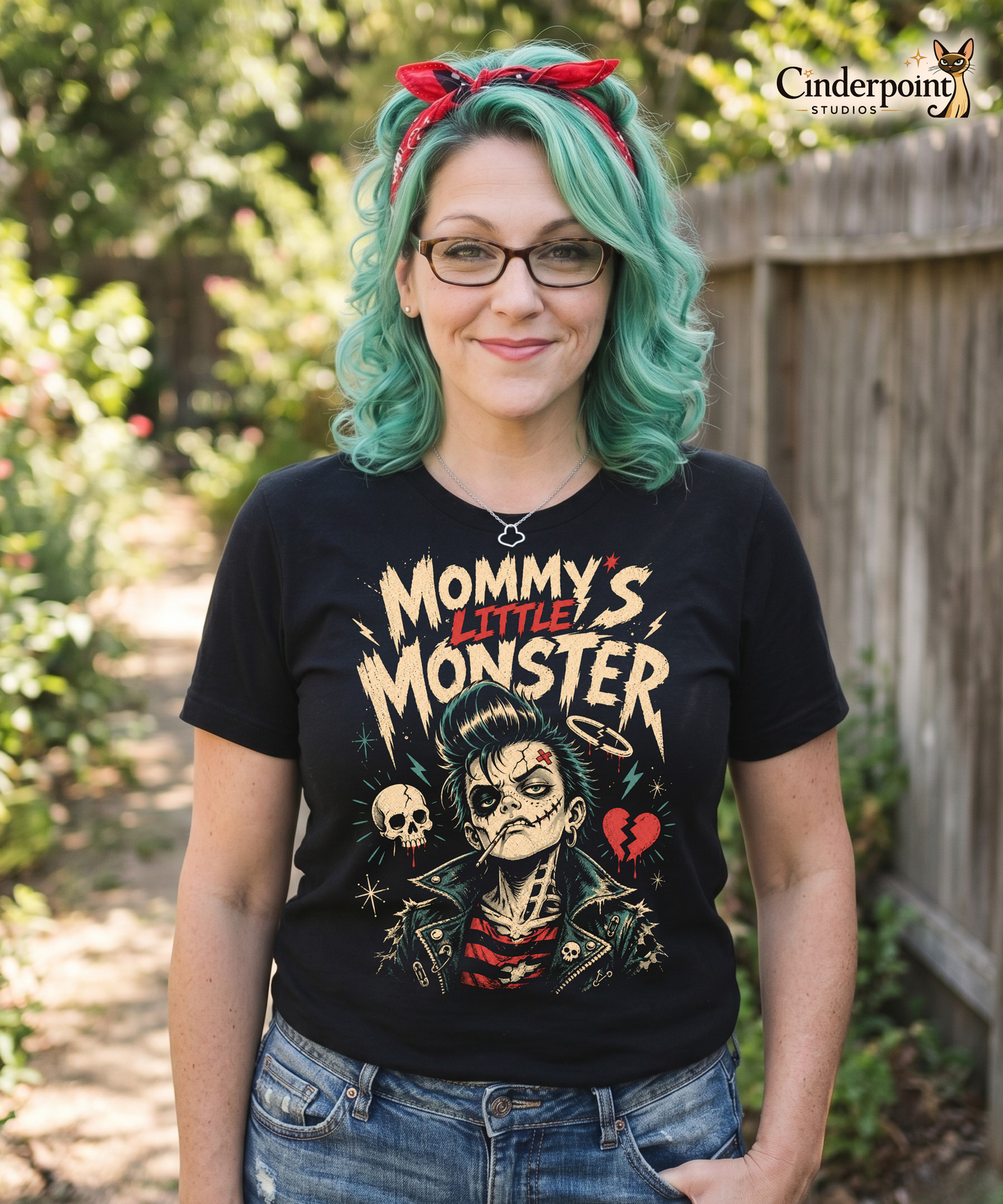 Auntie Mel wearing a retro lowbrow-style graphic on a black t-shirt featuring a green-skinned monster child with a black pompadour, stitched facial details, and leather jacket.