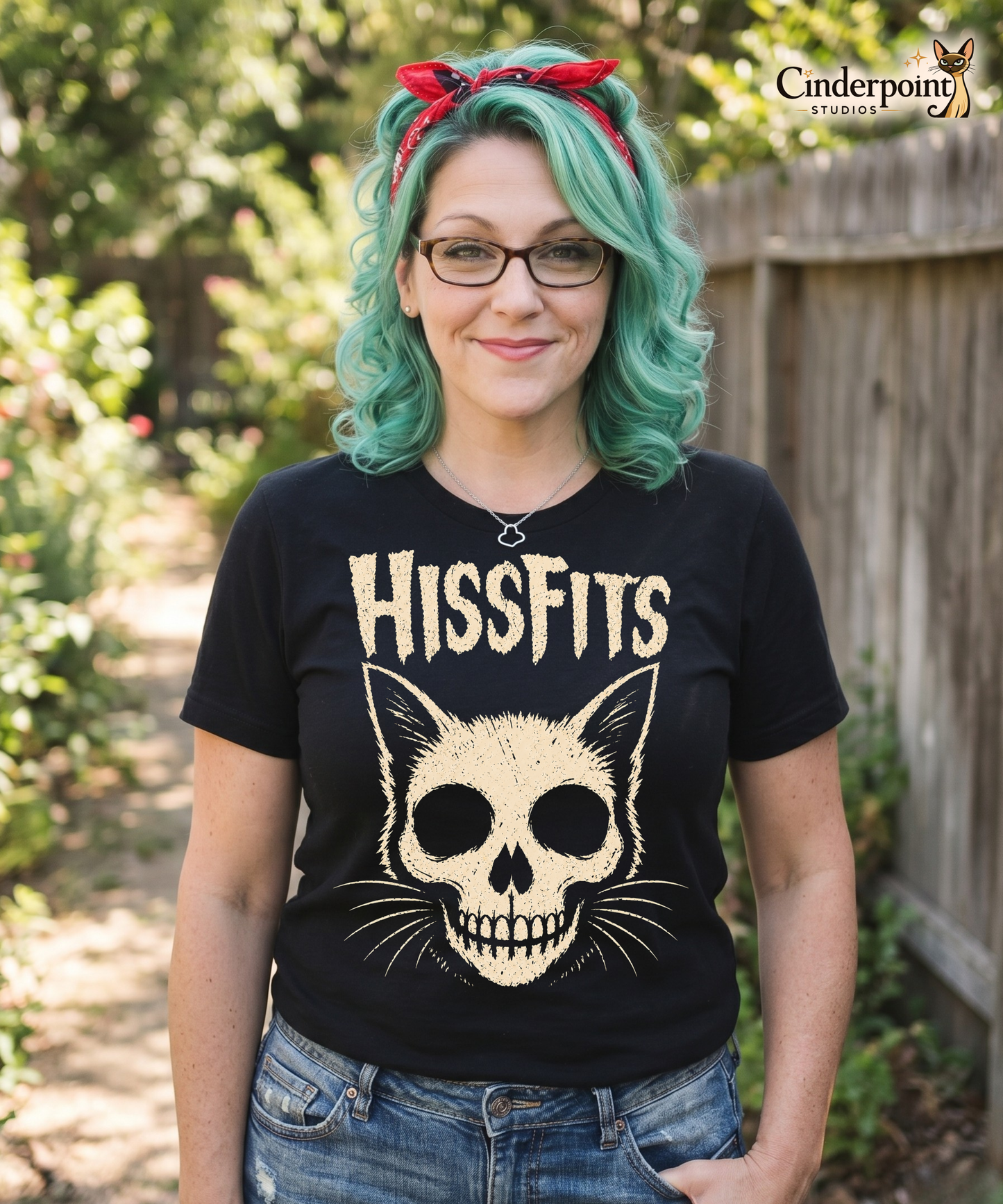 A retro horror-style graphic on a black t-shirt featuring a stylized cat skull with whiskers and pointed ears, with "HISSFITS" in iconic distressed punk-rock lettering.