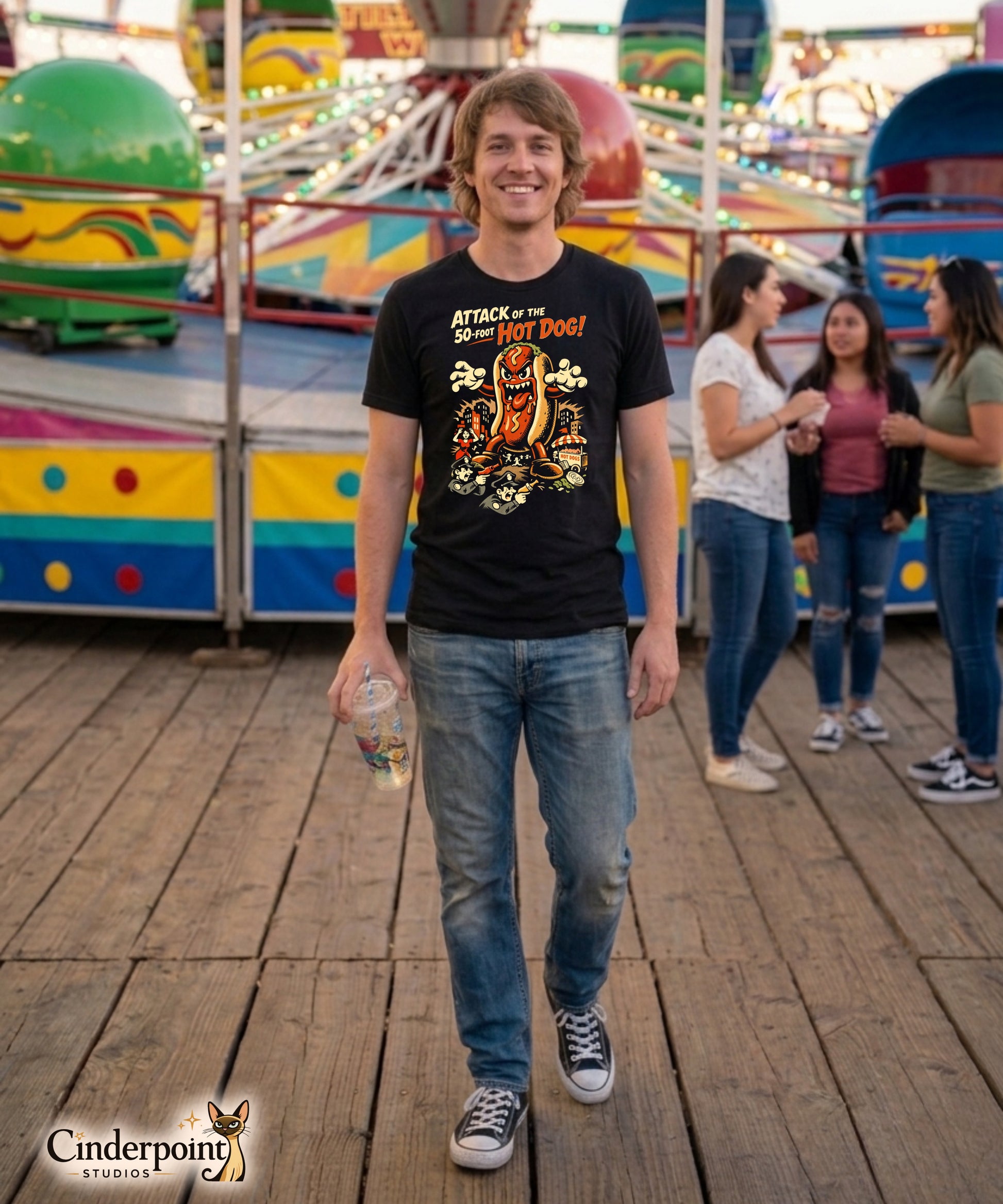 A retro B-movie style graphic t-shirt featuring a giant 50-foot hot dog attacking a vintage city skyline, with campy horror-themed cinematic lettering.
