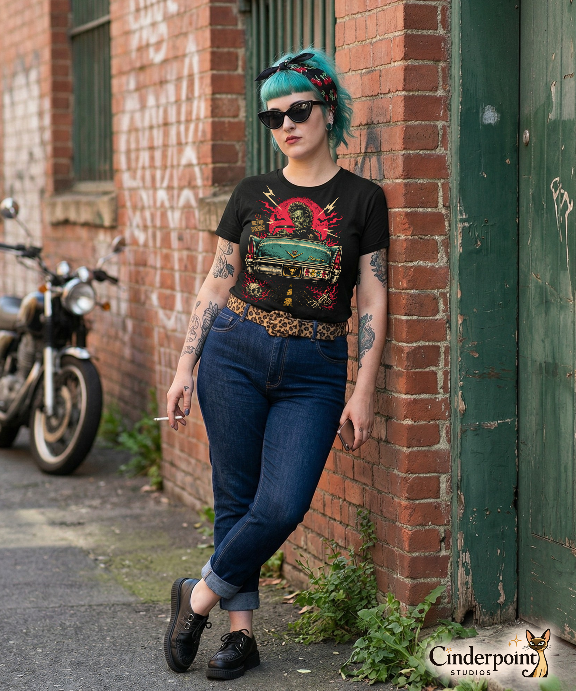Punk girl with teal hair is wearing  A retro graphic on a black t-shirt featuring a horror punk zombie driver and the rear end of a vintage Cadillac with grateful dead bumper sticker