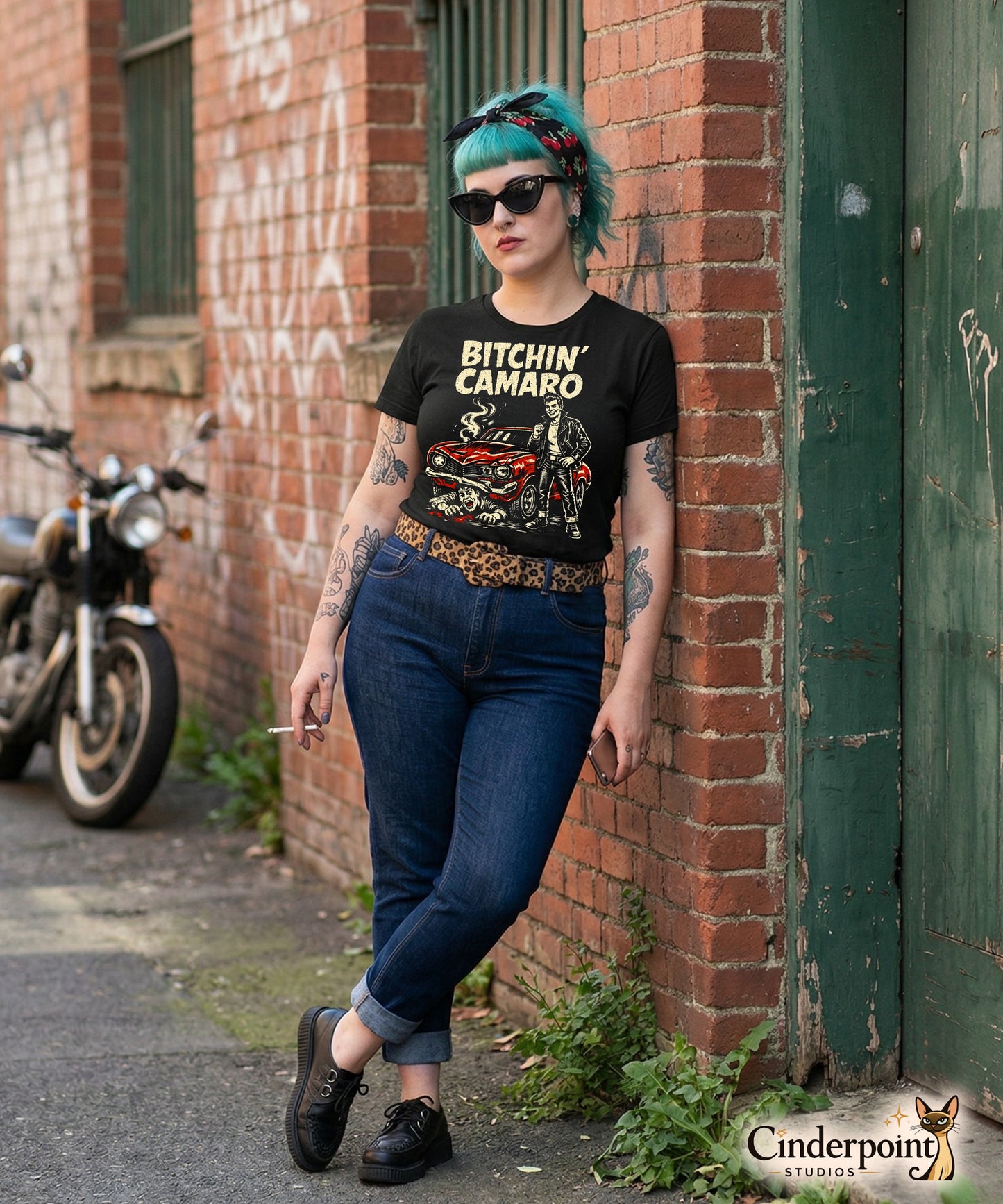 A retro-style graphic t-shirt featuring a stylized vintage Camaro muscle car with "Bitchin Camaro" in bold, distressed punk-rock lettering.