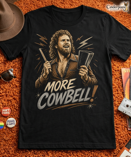 A gritty, woodcut-style illustration on a black t-shirt featuring a bearded man with curly hair and an open-collared 70s shirt holding a cowbell and drumstick, with the text 'MORE COWBELL!' in a distressed font.