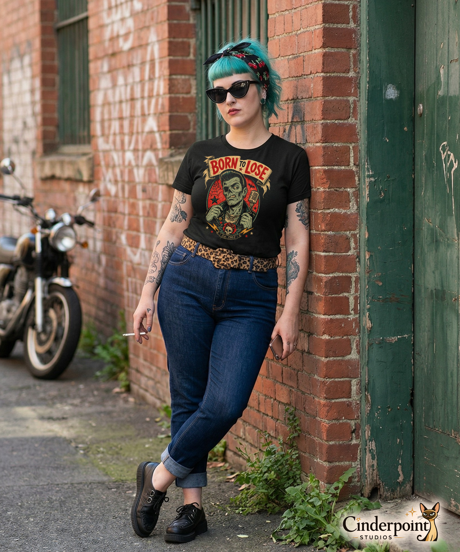 A psychobilly girl wearing A vintage tattoo flash-style graphic on a black t-shirt featuring a green-skinned zombie monster with a banner that says "Born to Lose"