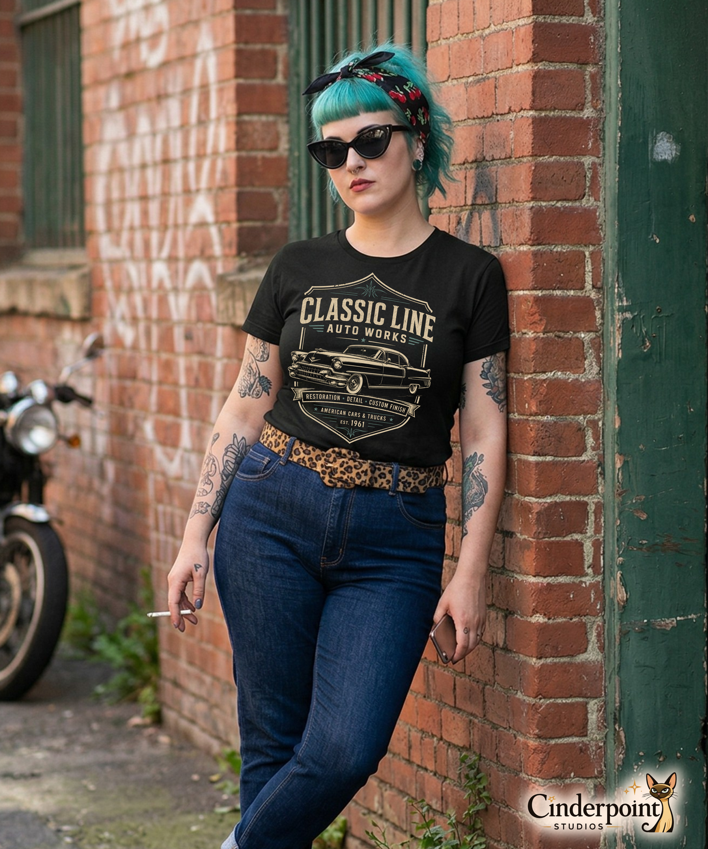 Punk girl leaning against a wall wearing a black graphic tee featuring original Cinderpoint Studios artwork for Classic Line Auto Works, a vintage restoration shop design with a 1950s-style classic car, bold lettering, badge-style frame, and text including Restoration Detail Custom Finish and American Cars & Trucks.