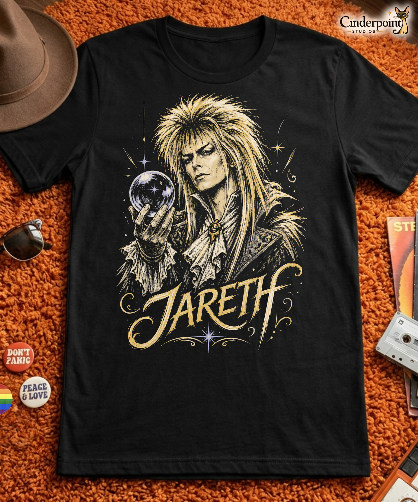 A gritty, high-contrast artistic portrait of Jareth the Goblin King on a black t-shirt, featuring his iconic 80s glam hair and a crystal ball with a starburst.
