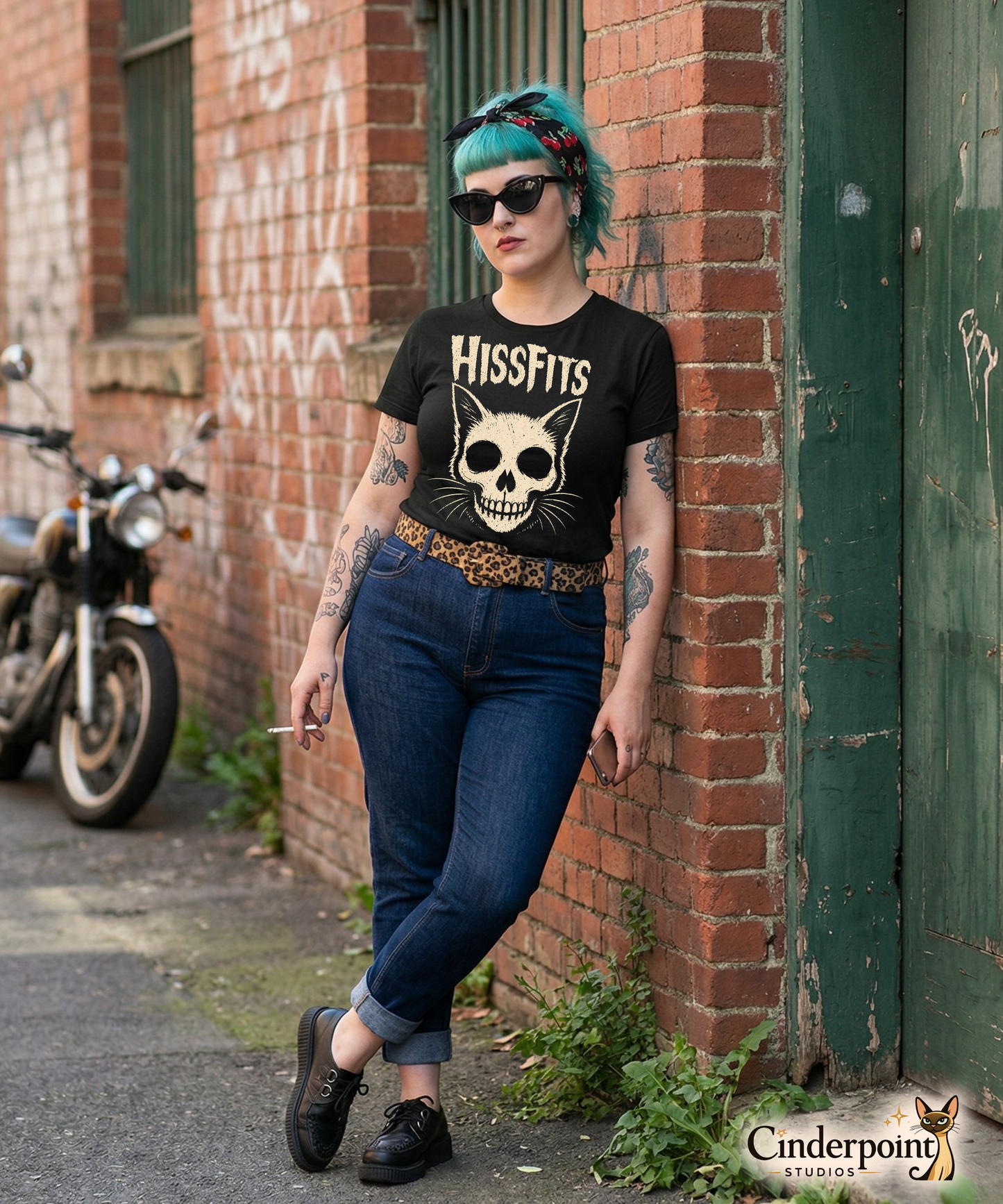 A retro horror-style graphic on a black t-shirt featuring a stylized cat skull with whiskers and pointed ears, with "HISSFITS" in iconic distressed punk-rock lettering.