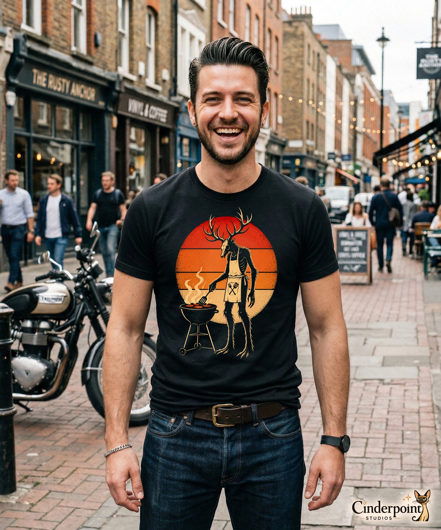 A retro-style graphic t-shirt featuring a Wendigo cryptid with antlers wearing a BBQ apron and grilling at a spatula, set against a vibrant 1980s neon sunset background.
