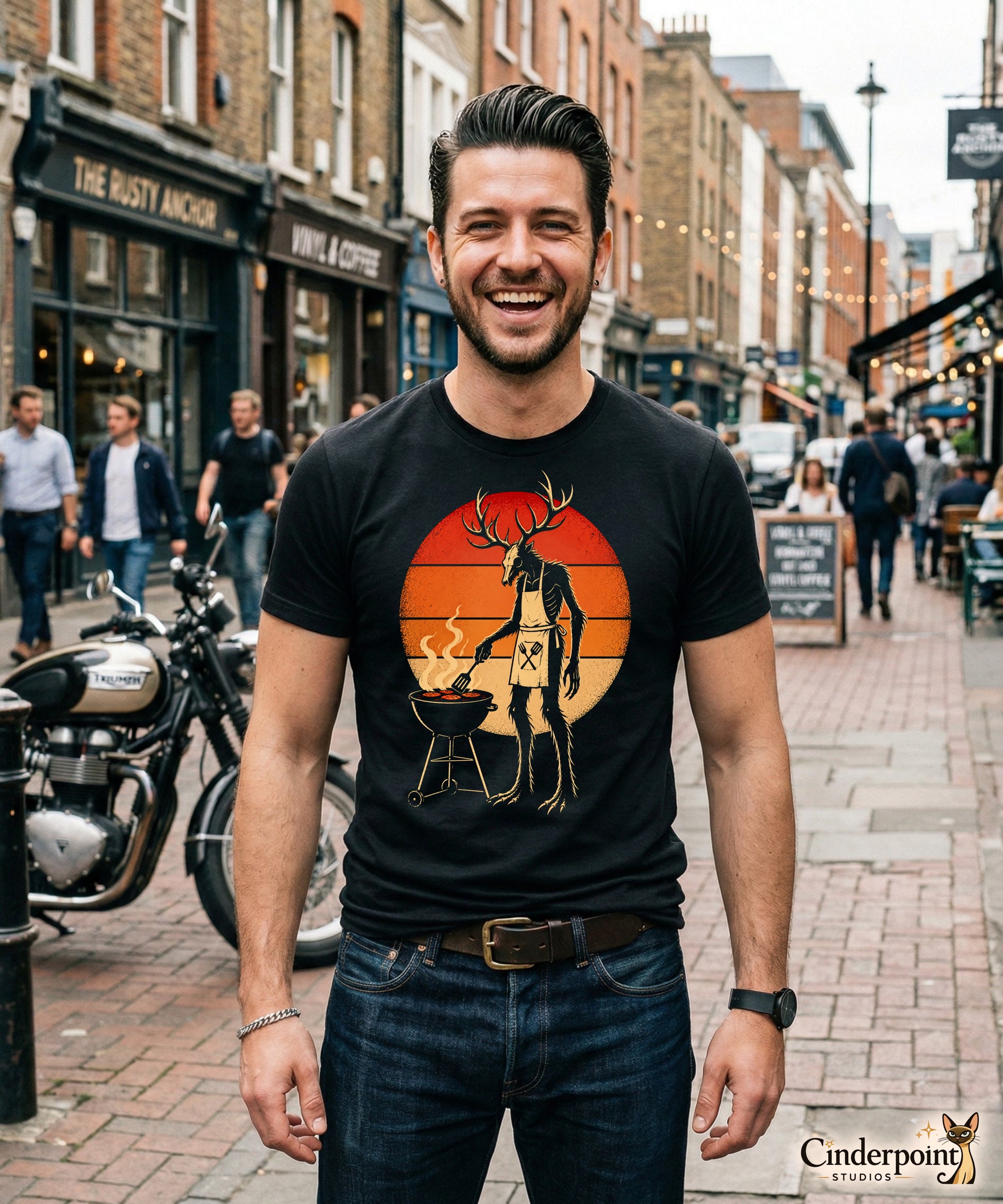 A retro-style graphic t-shirt featuring a Wendigo cryptid with antlers wearing a BBQ apron and grilling at a spatula, set against a vibrant 1980s neon sunset background.
