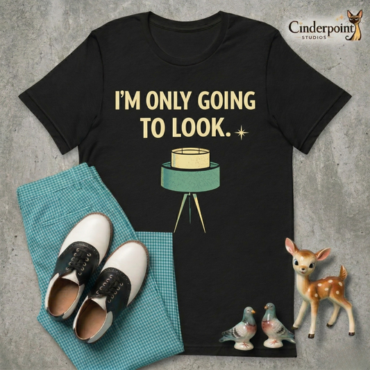 A top-down flat-lay on a grey concrete surface featuring the 'I'm Only Going To Look' black tee. Included are teal gingham pants, black and white saddle shoes, and vintage ceramic figurines.