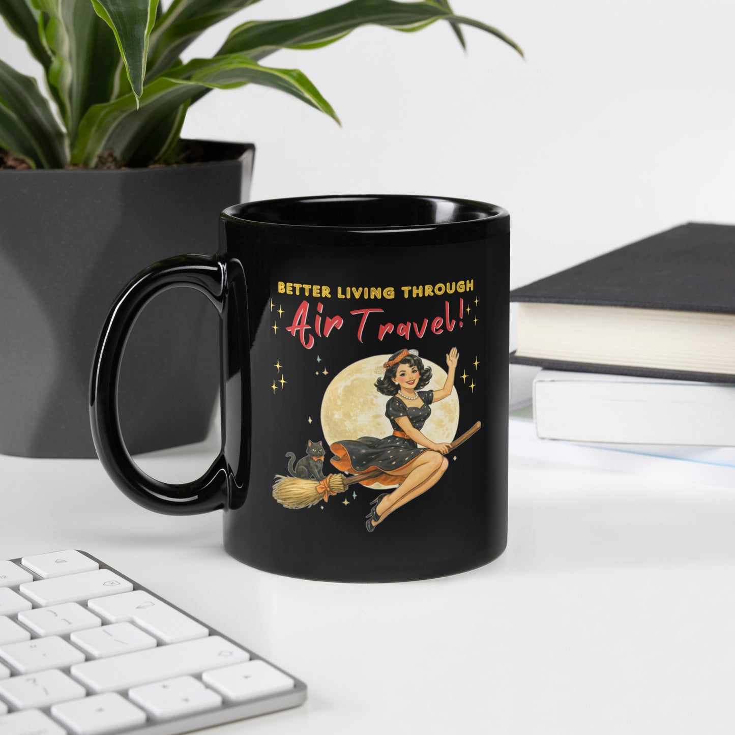 Better Living Through Air Travel black ceramic mug — vintage retro pinup witch in black polka dot dress and stewardess hat riding a broom in front of a full moon with dapper black cat familiar in orange bow tie, printed on both sides by Cinderpoint Studios