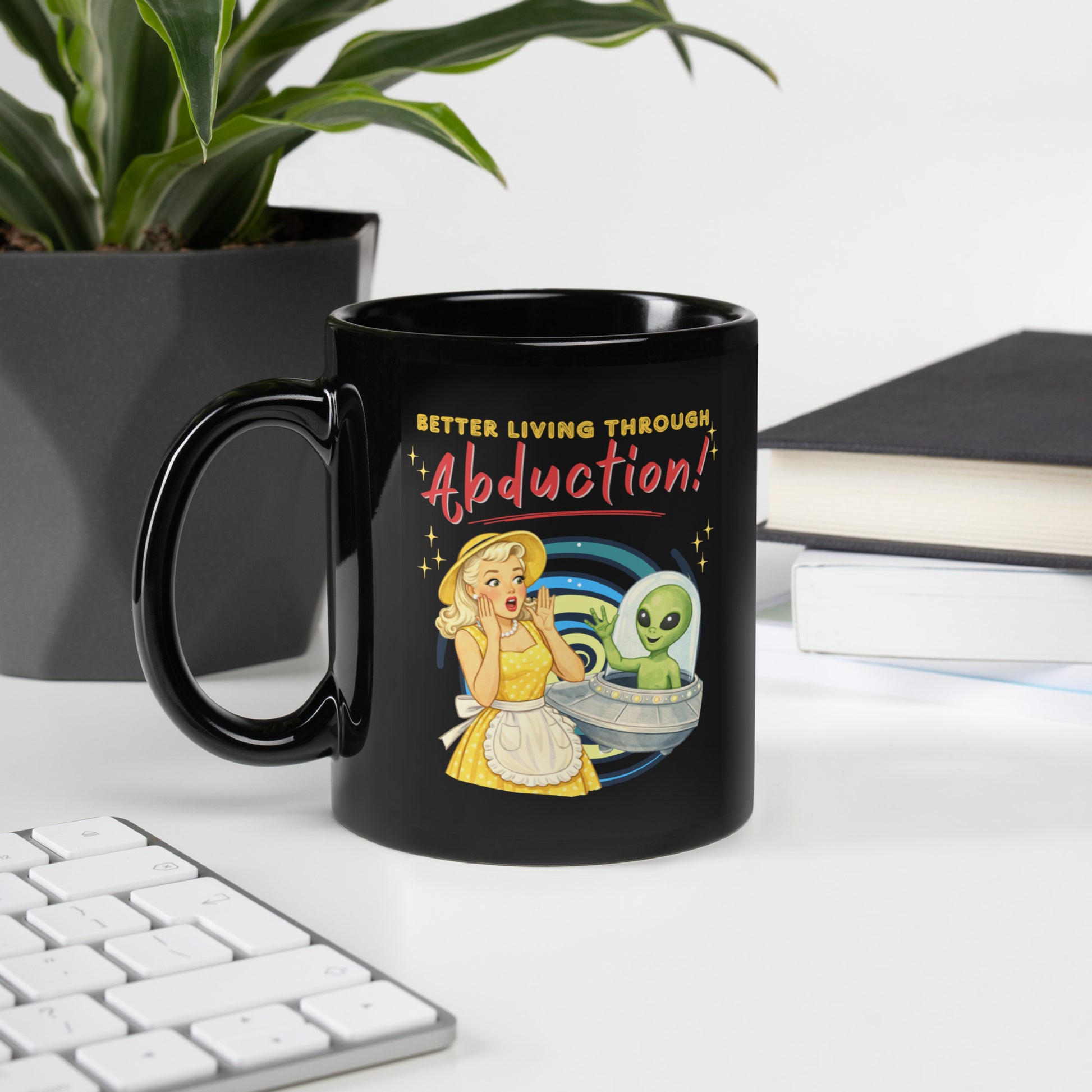 Better Living Through Abduction black ceramic mug — vintage 1950s retro blonde housewife in yellow polka dot dress reacting with delight to a friendly green alien waving from a silver saucer, printed on both sides by Cinderpoint Studios