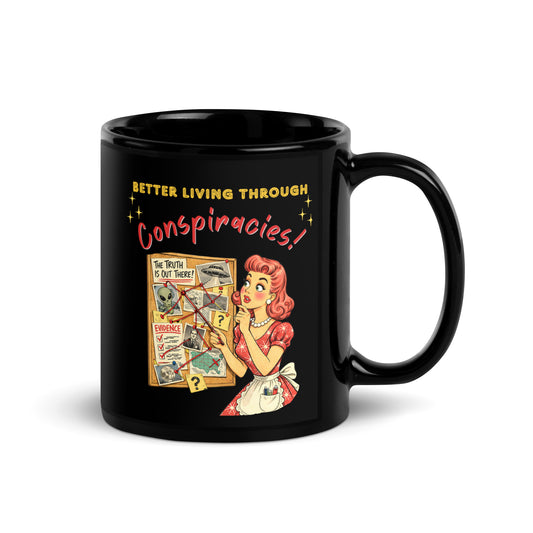 Better Living Through Conspiracies black ceramic mug — vintage 1950s retro housewife pointing at alien evidence cork board with red string and UFO photos, printed on both sides by Cinderpoint Studios