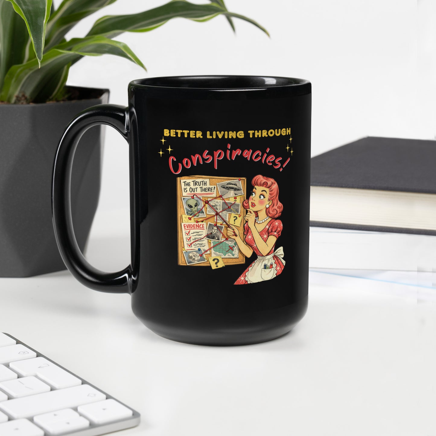 Better Living Through Conspiracies black ceramic mug — vintage 1950s retro housewife pointing at alien evidence cork board with red string and UFO photos, printed on both sides by Cinderpoint Studios