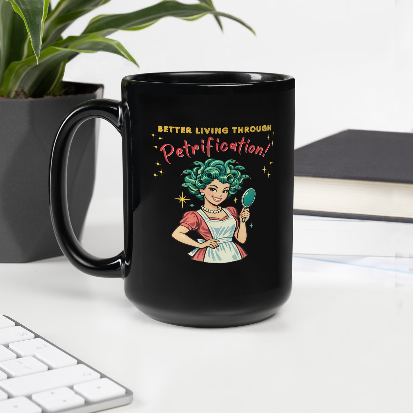 Better Living Through Petrification black ceramic mug — vintage 1950s retro Medusa housewife with styled snake hair holding a hand mirror and smiling confidently in pearls and apron, printed on both sides by Cinderpoint Studios